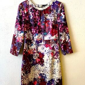 Pretty little pink and purple dress with flowers. She is new and beautiful.